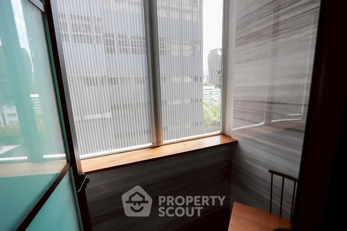 Cozy balcony with city view, perfect for relaxation and enjoying urban scenery.