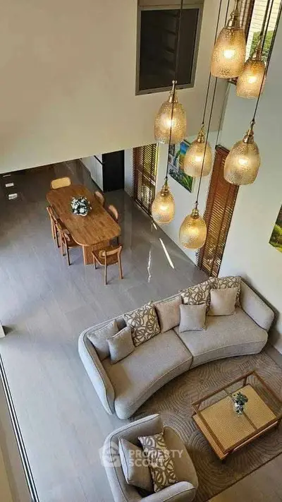 Luxurious open-plan living room with elegant lighting and modern furniture