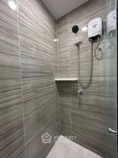 Modern bathroom with sleek tiled shower and electric water heater
