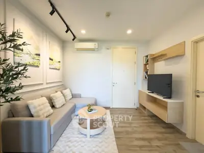 Modern living room with stylish decor and cozy seating in a bright apartment.