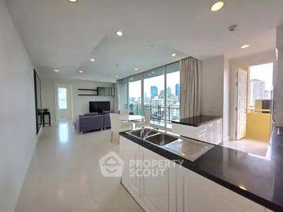 Spacious modern living room with open kitchen and city view
