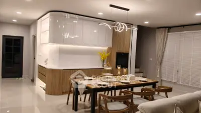 Modern kitchen and dining area with stylish lighting and wooden accents