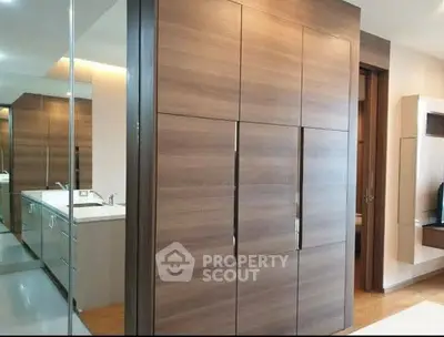 Modern bedroom with sleek wooden wardrobe and stylish interior design