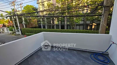 Spacious balcony with modern tiles and lush greenery view