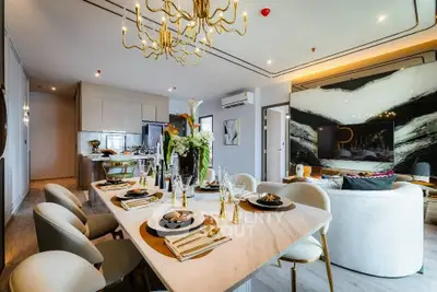Luxurious open-plan living and dining area with elegant decor and modern kitchen.