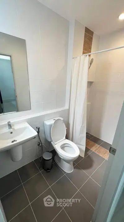 Modern bathroom with sleek design and shower area in a contemporary home.