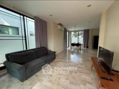 Spacious modern living room with sleek furniture and large windows