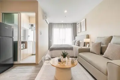 Modern studio apartment with cozy living area and stylish kitchen