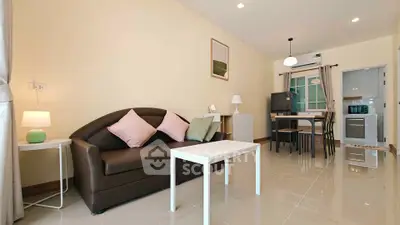 Modern living room with sleek furniture and open kitchen layout