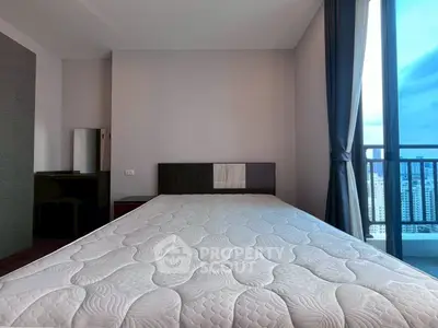 Spacious bedroom with large window and city view, featuring modern decor and ample natural light.