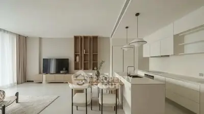 Modern open-layout living room and kitchen with sleek design and neutral tones.