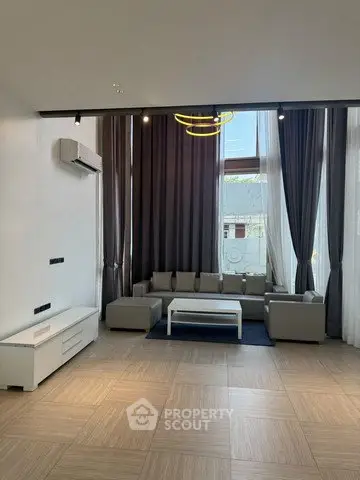 Spacious modern living room with high ceilings and elegant decor