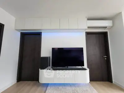 Modern living room with sleek TV setup and stylish cabinetry