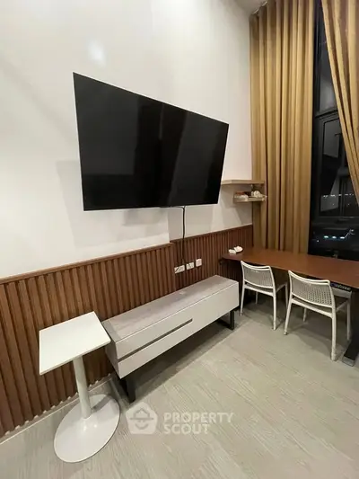 Modern living room with wall-mounted TV and stylish furniture