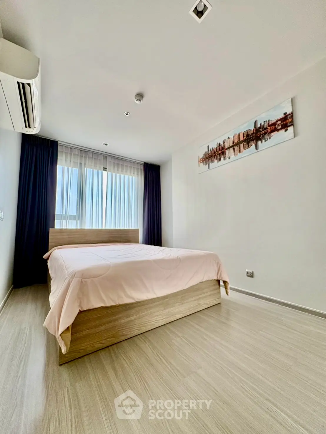 Modern minimalist bedroom with wooden flooring and stylish decor