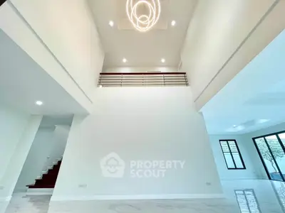 Spacious modern living room with high ceilings and elegant lighting in a luxury home.
