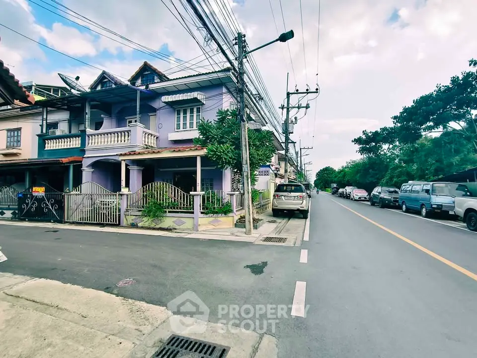 Charming residential street view with colorful houses and lush greenery, perfect for serene living.