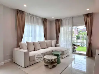 Elegant living room with modern sofa and garden view, perfect for relaxation and entertaining.