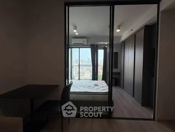 Modern bedroom with city view and sliding glass doors