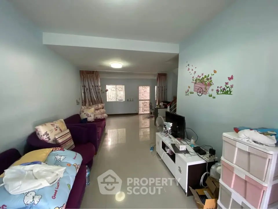 Spacious living room with cozy sofas and charming wall decor in a modern apartment.