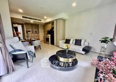 Modern living room with elegant decor and open kitchen layout
