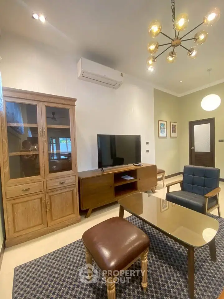 Charming living room with modern furniture and stylish lighting, perfect for relaxation and entertainment.