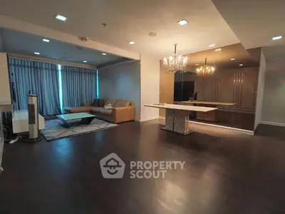 Spacious modern living room with elegant chandelier and cozy seating area