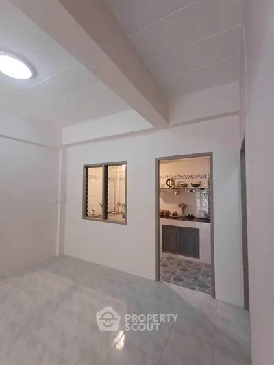 Spacious interior with modern kitchen and tiled flooring, perfect for comfortable living.