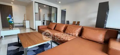 Spacious modern living room with brown leather sofa and stylish decor