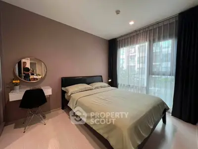 Modern bedroom with large window and stylish decor in urban apartment