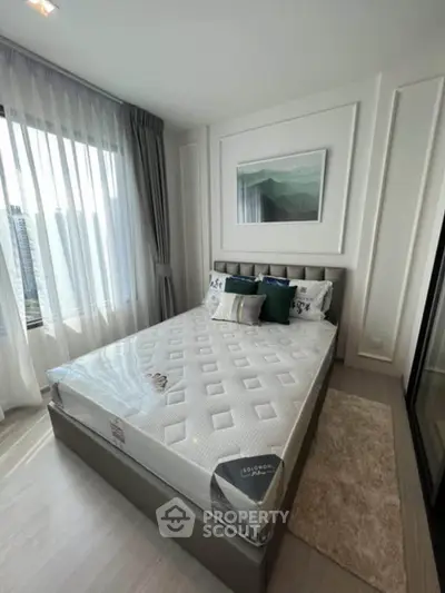 Modern bedroom with large window and stylish decor in a high-rise apartment.