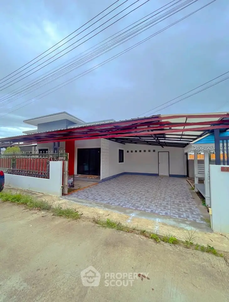 Modern single-story house with spacious carport and tiled driveway