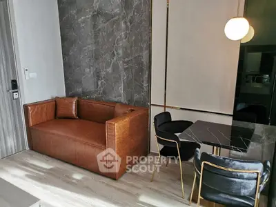 Modern living room with leather sofa and stylish dining area