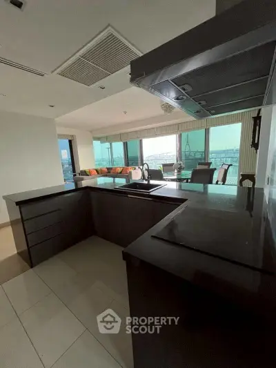 Spacious open-layout kitchen with modern design and large windows offering a stunning view.