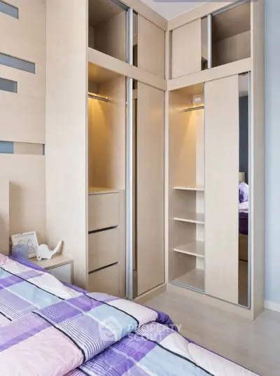 Modern bedroom with built-in wooden wardrobe and stylish bedding