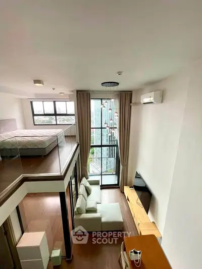 Modern loft apartment with high ceilings and large windows offering stunning city views.