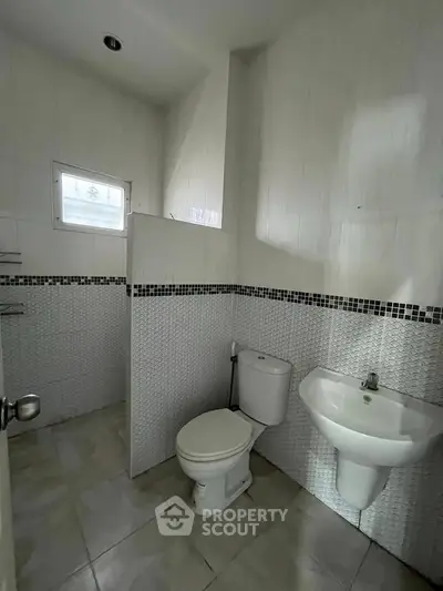 Modern bathroom with sleek white tiles and compact design