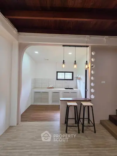 Charming kitchen with open layout and stylish lighting in modern home