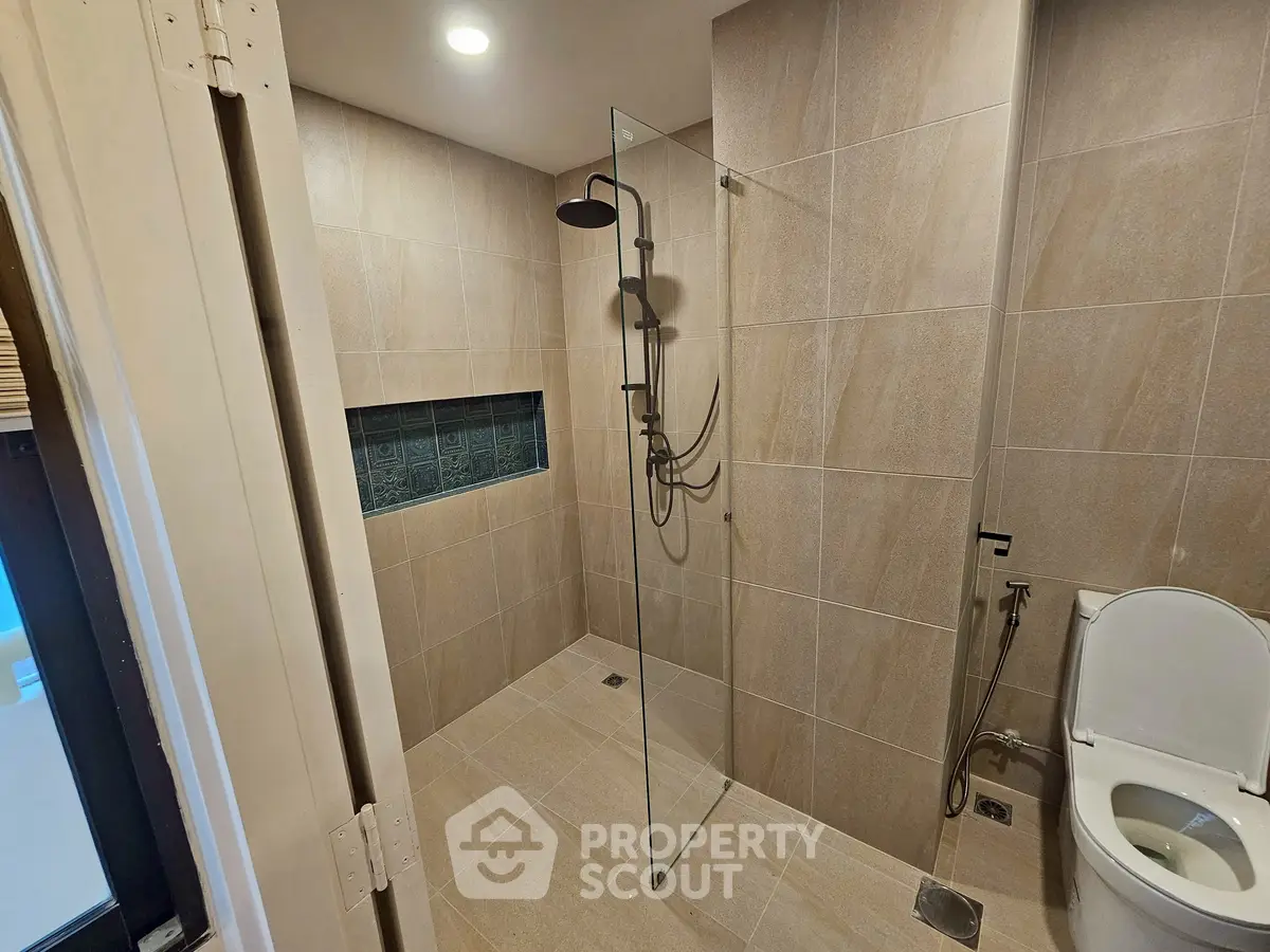 Modern bathroom with glass shower and sleek tile design