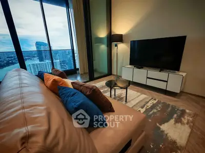 Luxurious living room with stunning city view, modern furniture, and cozy ambiance.
