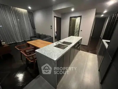 Modern open-layout kitchen with sleek design and cozy living area.