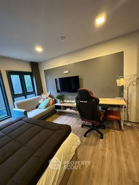Modern studio apartment with cozy living area and workspace