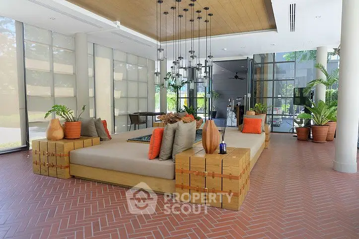 Luxurious modern living room with stylish decor and large windows offering natural light.