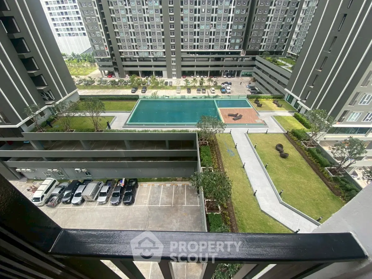 Modern condominium with pool and landscaped garden view from balcony