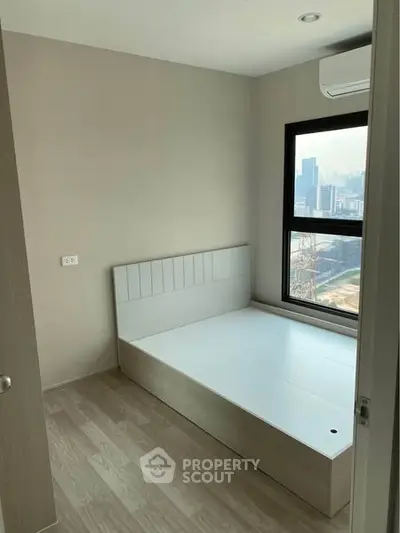 Modern minimalist bedroom with city view and air conditioning