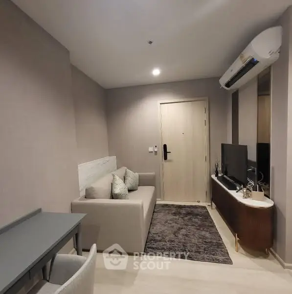 Modern living room with sleek furniture and air conditioning, perfect for urban living.