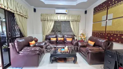 Luxurious living room with leather sofas and elegant decor, perfect for relaxation and entertainment.