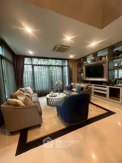 Luxurious living room with elegant decor and large windows offering natural light.