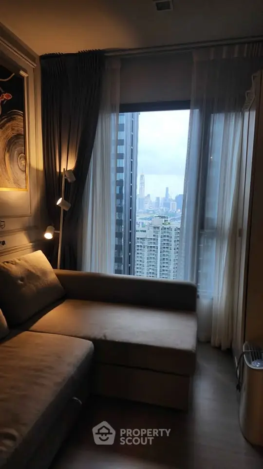 Cozy living room with a stunning city view through large windows, perfect for urban living.