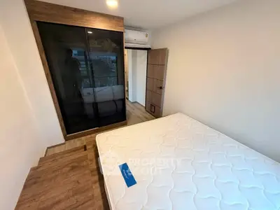 Modern bedroom with wooden flooring and built-in wardrobe